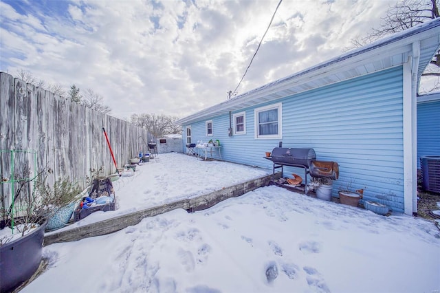 yard covered in snow featuring cooling unit