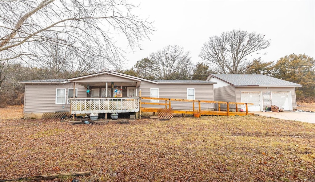 manufactured / mobile home with a porch and a garage