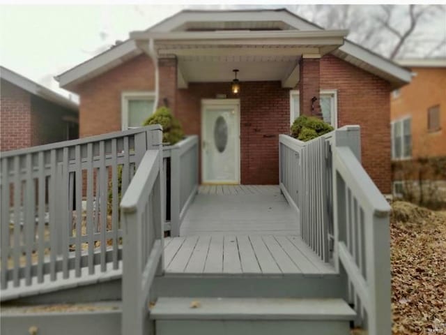 entrance to property featuring a deck