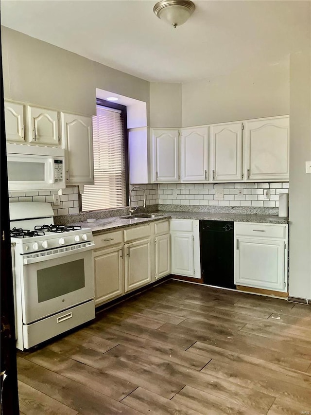 kitchen featuring backsplash, white appliances, dark wood-type flooring, sink, and white cabinets