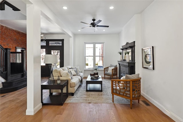 living room featuring ceiling fan and light wood-type flooring