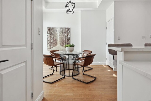 dining room with an inviting chandelier and light hardwood / wood-style floors