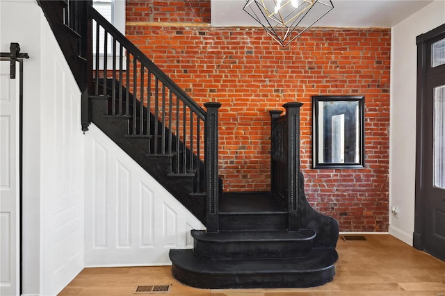 stairway featuring wood-type flooring