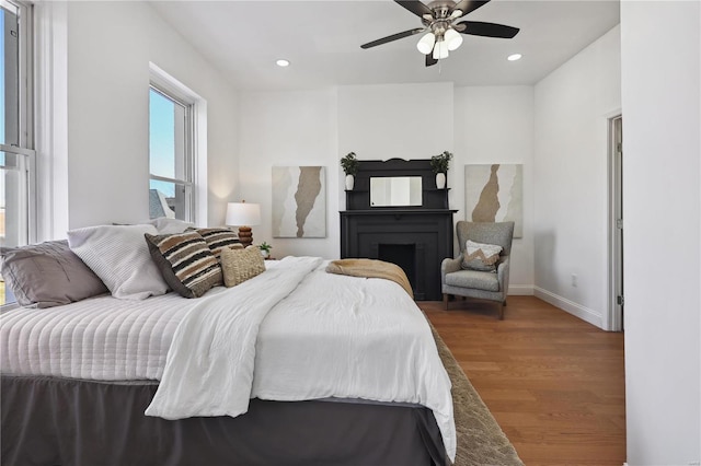 bedroom featuring wood-type flooring and ceiling fan