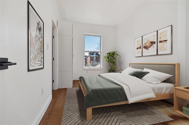 bedroom with hardwood / wood-style flooring