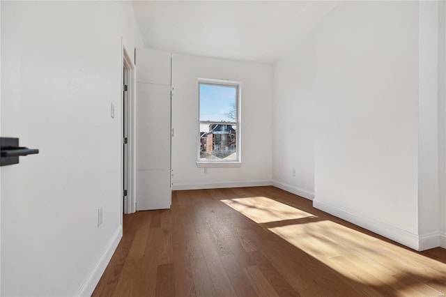 spare room with hardwood / wood-style floors