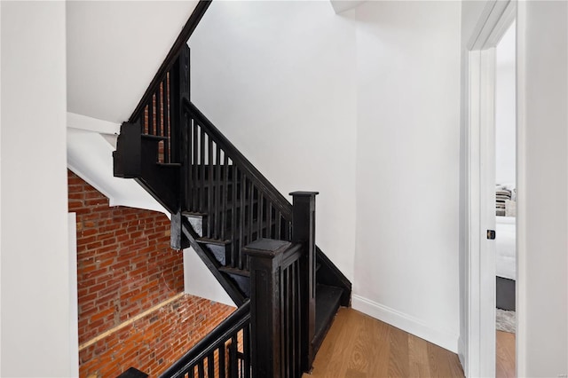 staircase with hardwood / wood-style floors