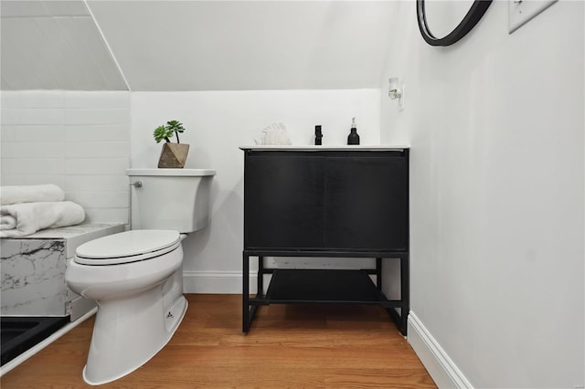 bathroom with hardwood / wood-style floors and toilet