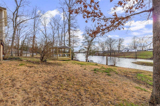 view of yard with a gazebo and a water view