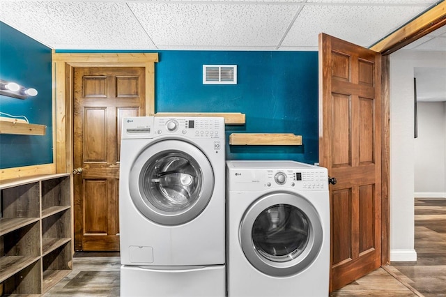 laundry area with hardwood / wood-style floors and separate washer and dryer