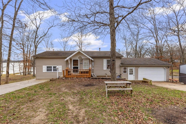 view of front of house with a water view, covered porch, and a garage