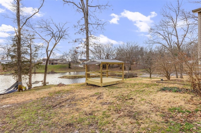 view of yard featuring a gazebo and a deck with water view