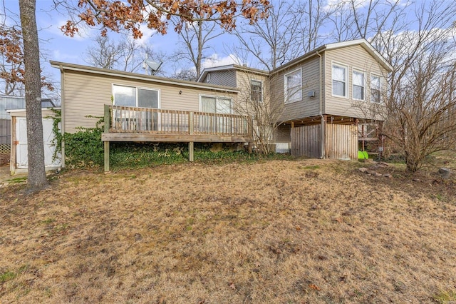 rear view of property featuring a wooden deck