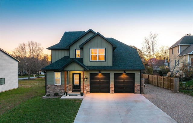 view of front of property with a garage and a lawn