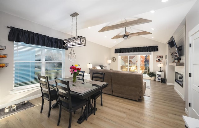 dining area with lofted ceiling with beams, light hardwood / wood-style floors, and ceiling fan