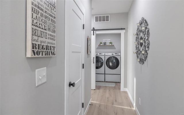 washroom featuring light hardwood / wood-style flooring and washer and dryer