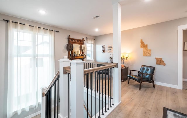 hallway with light hardwood / wood-style floors