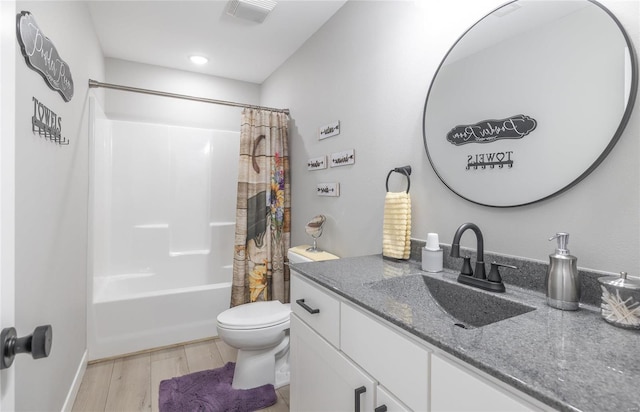 full bathroom with hardwood / wood-style flooring, vanity, toilet, and shower / tub combo with curtain