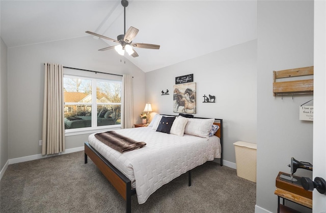 carpeted bedroom with ceiling fan and vaulted ceiling