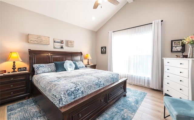 bedroom featuring vaulted ceiling, light wood-style floors, and ceiling fan