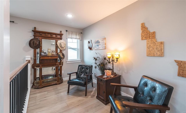 living area with light wood finished floors and baseboards