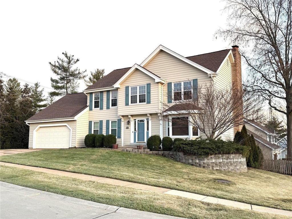 view of front of home featuring a garage and a front yard