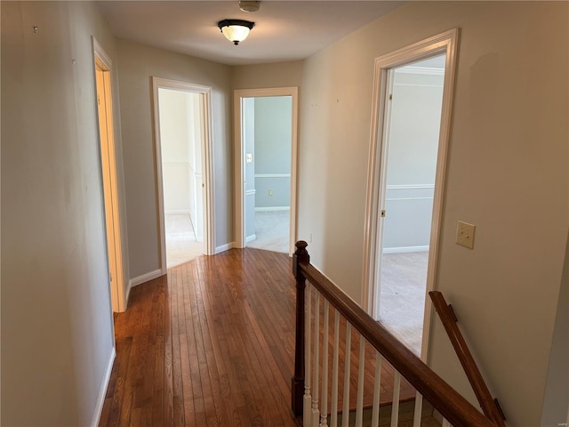 corridor with hardwood / wood-style flooring