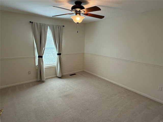 carpeted spare room featuring ceiling fan