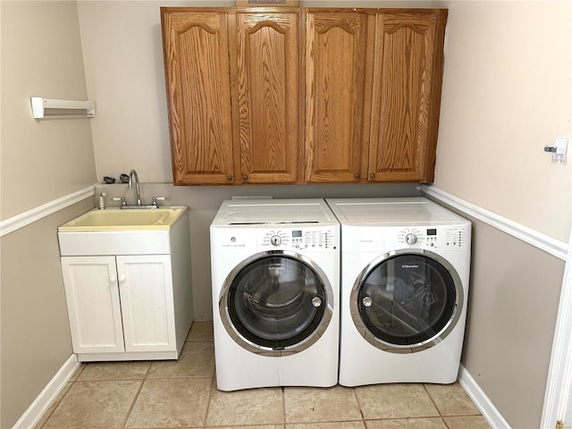 laundry area featuring independent washer and dryer, cabinets, and sink