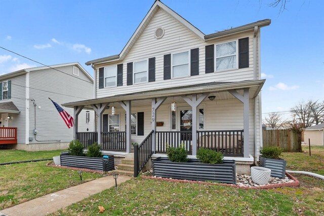 view of front of home featuring a front lawn and a porch