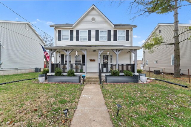 view of front of home featuring a front yard and central air condition unit