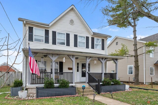 view of front of property with a front yard and a porch