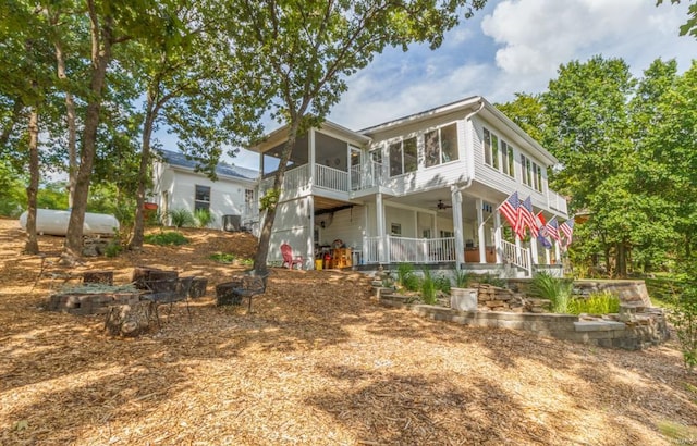 rear view of house with a porch, ceiling fan, and a sunroom