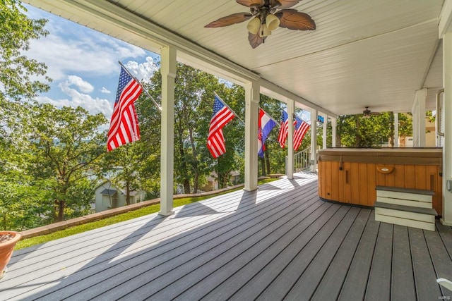 wooden terrace featuring covered porch, a hot tub, and ceiling fan