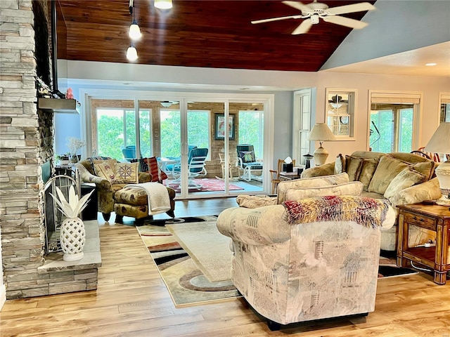 living room with light hardwood / wood-style flooring, wooden ceiling, and vaulted ceiling