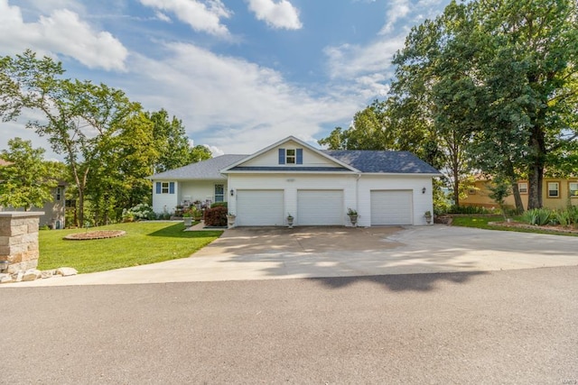 view of front facade with a front yard and a garage