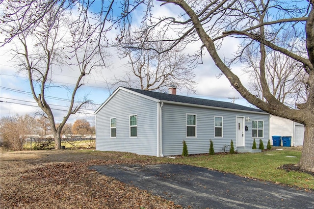 view of side of home featuring a lawn