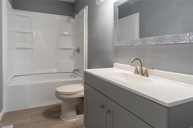 full bathroom with wood-type flooring, vanity, shower / bath combination, and toilet