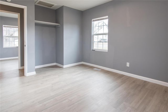 unfurnished bedroom featuring light hardwood / wood-style floors and a closet