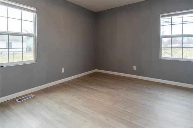 spare room featuring light hardwood / wood-style floors