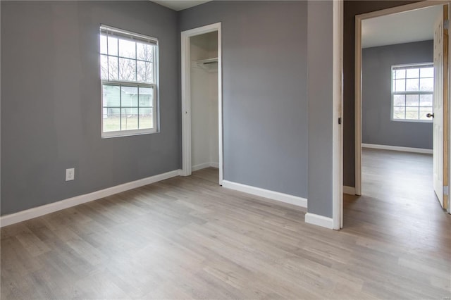 unfurnished bedroom with light hardwood / wood-style floors and a closet