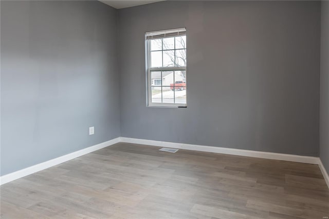 spare room featuring light hardwood / wood-style floors