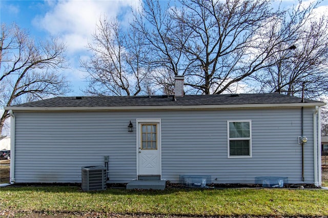 back of house featuring a lawn and central AC