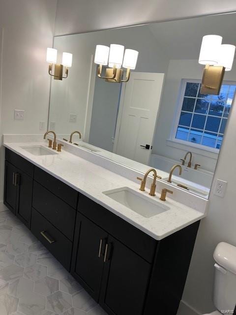 bathroom with toilet and vanity