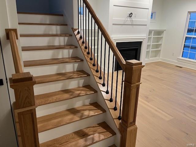 stairs featuring hardwood / wood-style flooring