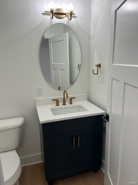 bathroom featuring hardwood / wood-style floors, toilet, and vanity