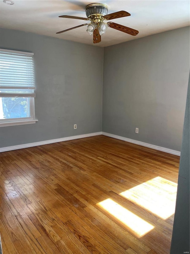 spare room with hardwood / wood-style floors and ceiling fan