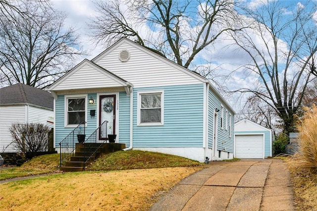 bungalow-style house with an outbuilding, a garage, and a front lawn