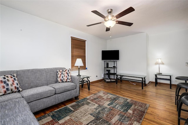 living room featuring ceiling fan and wood-type flooring