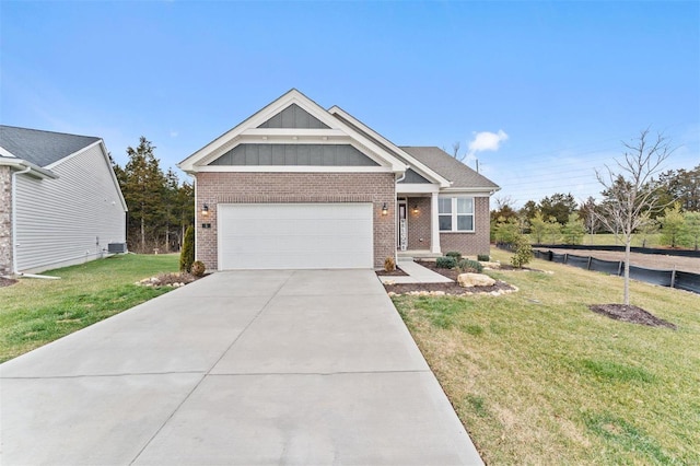 craftsman-style home featuring driveway, a front lawn, board and batten siding, and brick siding